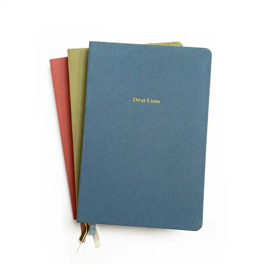 A personalized linen-bound journal in various colors, a thoughtful and creative 12-Year Anniversary Gift.