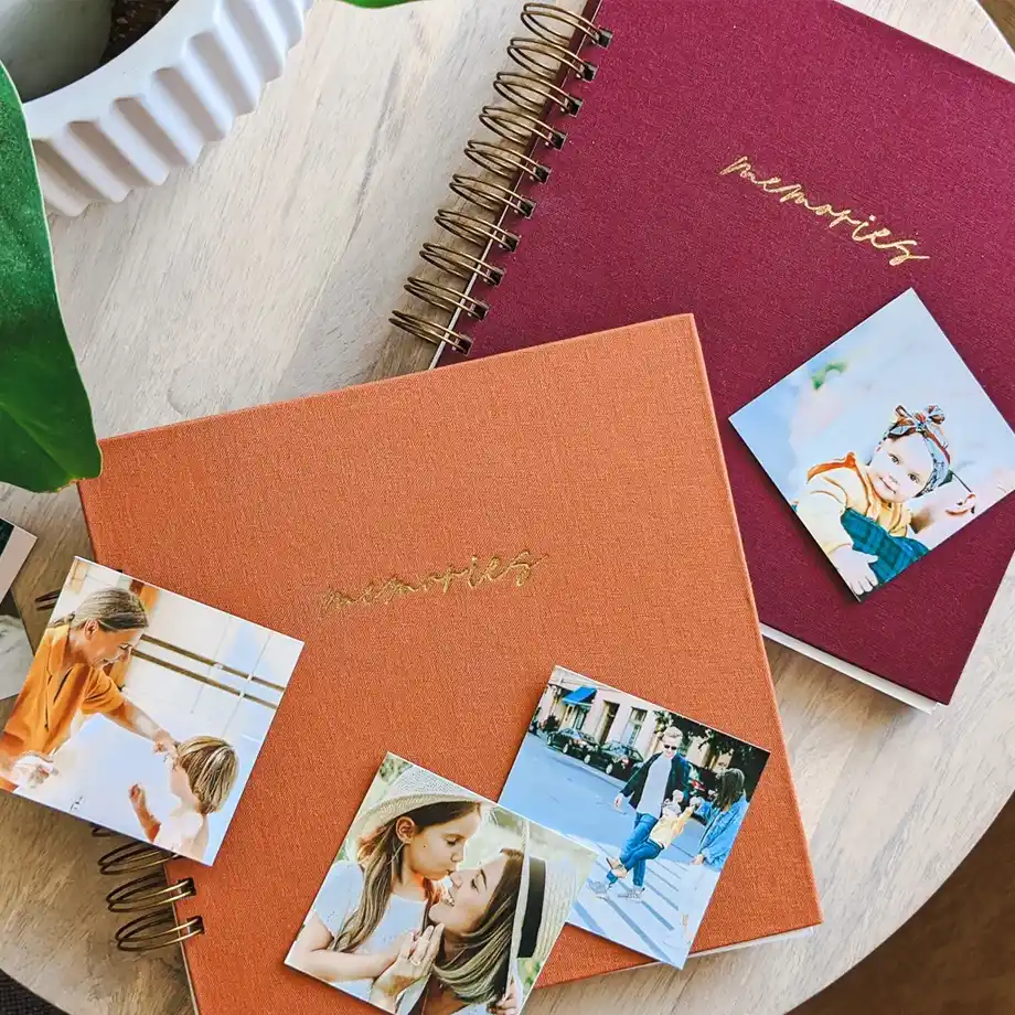 Colorful linen scrapbooks with 'Memories' embossed on the cover, a sentimental 12-Year Anniversary Gift idea.