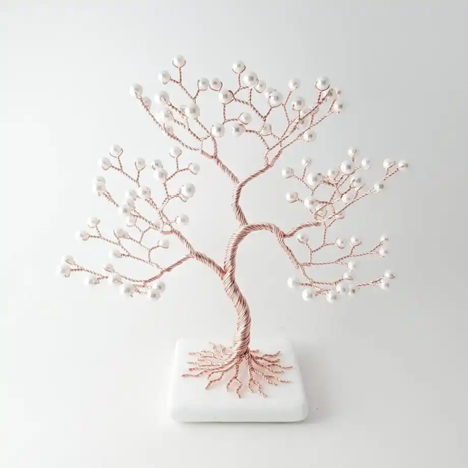 A handcrafted pearl wire tree sculpture on a white marble base, symbolizing growth and love for a 12-year anniversary gift.