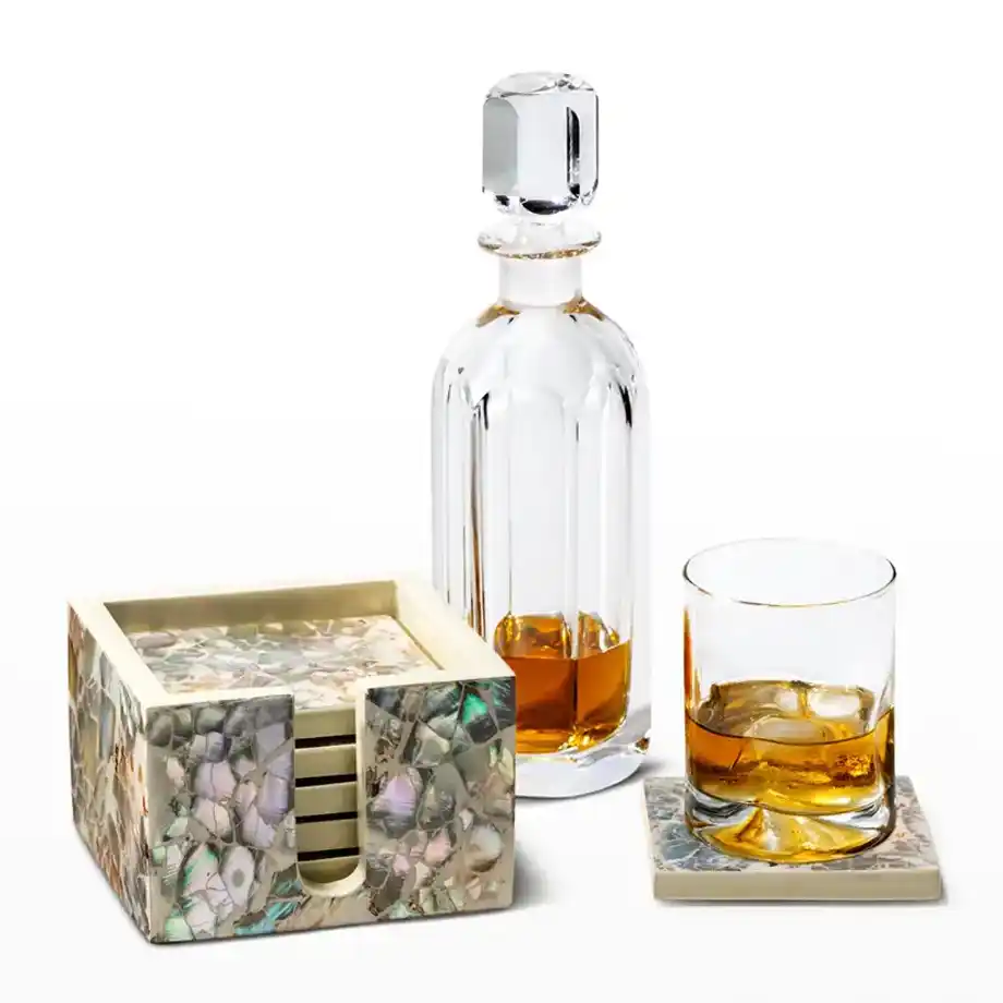 A crystal decanter with coasters and glasses featuring mother-of-pearl accents, a luxurious 12-year anniversary gift