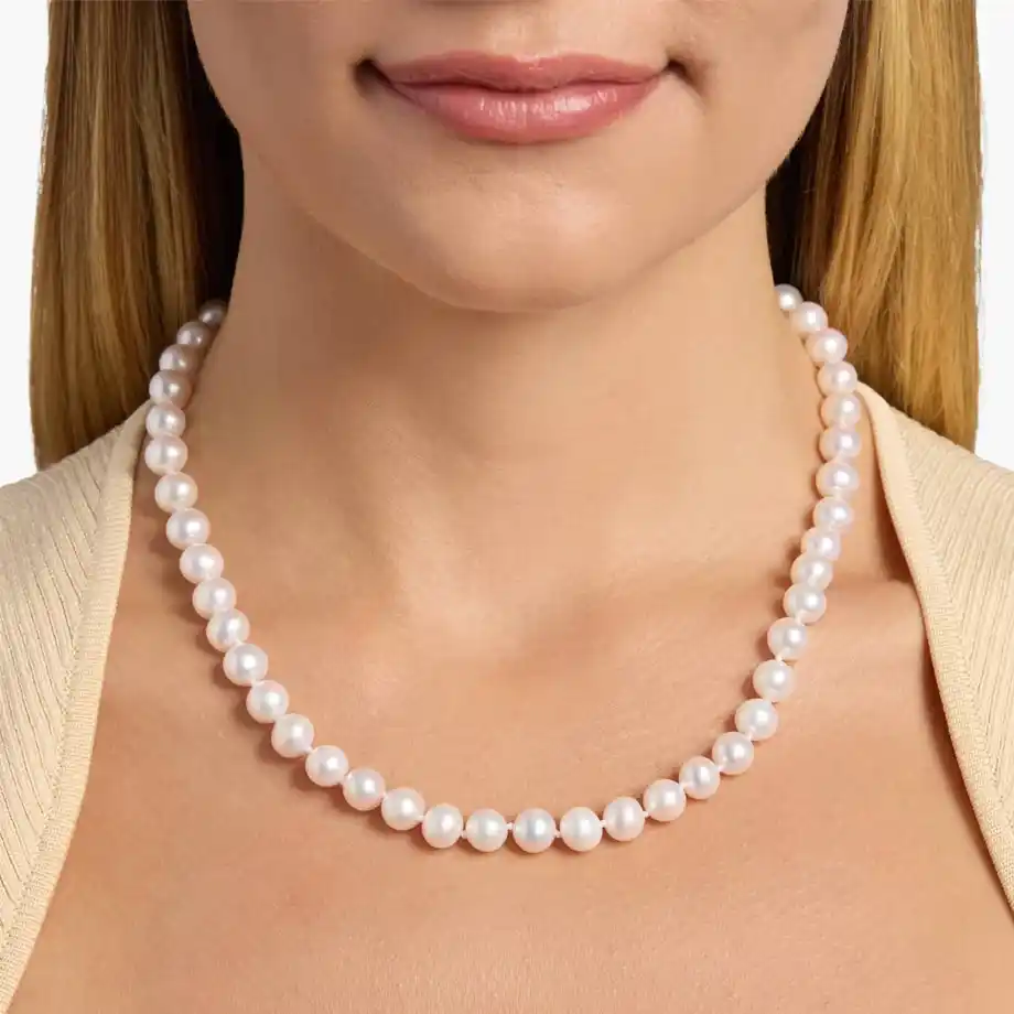 A timeless pearl necklace worn with elegance, a meaningful and traditional 12-year anniversary gift.