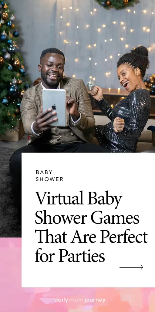 A couple laughing and celebrating while playing virtual baby shower games on a tablet, seated near a beautifully lit Christmas tree, bringing fun to their baby shower celebration.