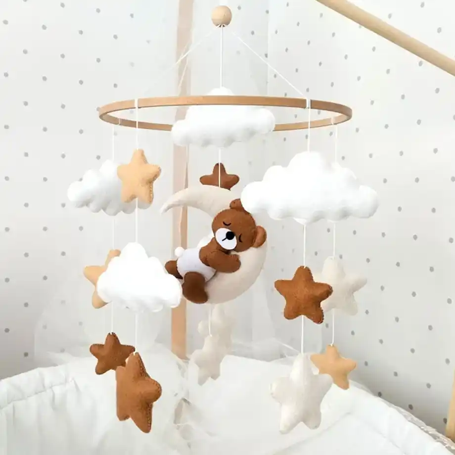 A charming baby crib mobile featuring a sleeping bear, perfect for adding a peaceful touch to any nursery. This handmade mobile makes a thoughtful and unique baby shower gift idea, bringing comfort and style to the baby’s room.






