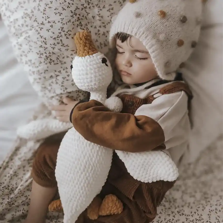 This adorable goose plushie sleeping toy is a cozy and soft handmade crochet creation, perfect for cuddles and comfort. It’s an ideal bedtime companion for 4-year-old boys, offering both a cute design and a gentle, soothing presence. As part of the best toys for 4-year-old boys, this plushie fosters imagination, relaxation, and emotional comfort, making it a wonderful addition to any child's toy collection. A perfect gift for nurturing warmth and security during nap time or sleep.