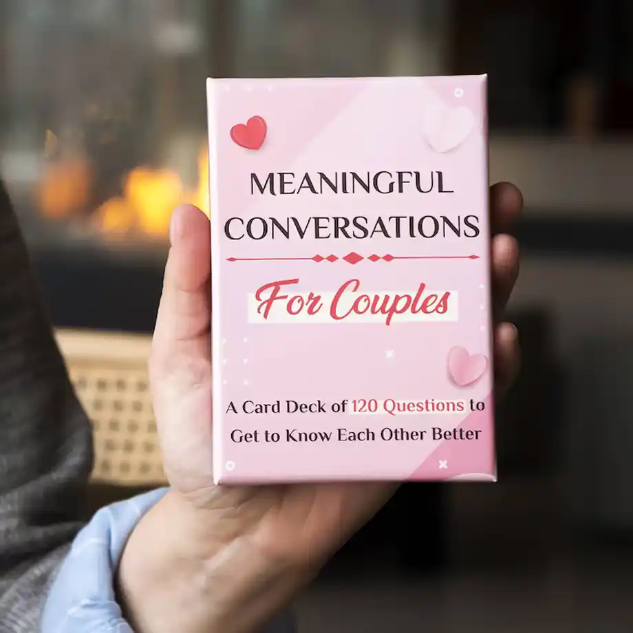 A pink card deck titled u0022Meaningful Conversations for Couples,u0022 featuring 120 thoughtful ice breaker questions designed to deepen connections and spark meaningful discussions between partners.