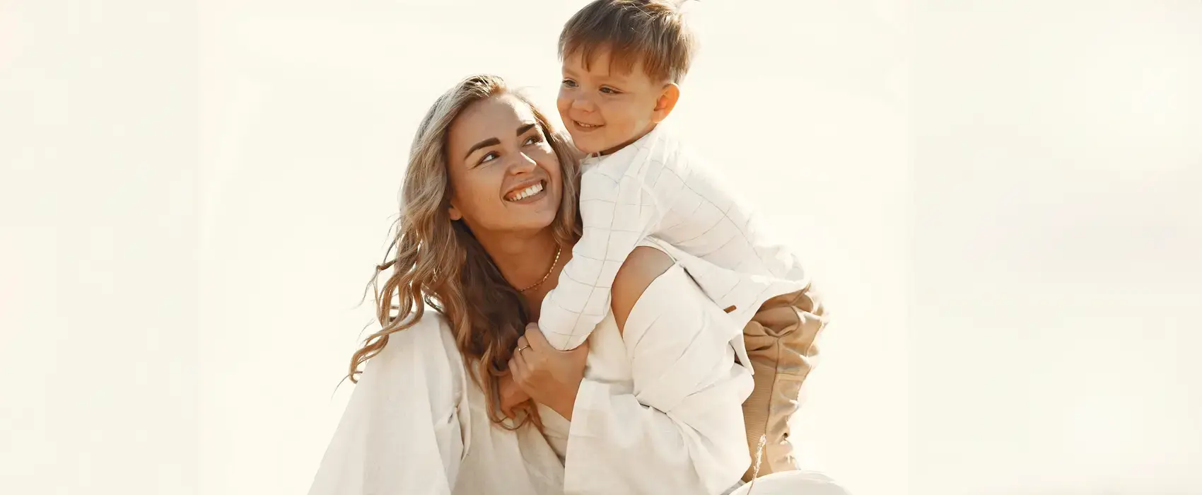 A touching moment of a young boy hugging his mother as she sits on a hay bale, symbolizing the deep love and connection reflected in Mother Son Quotes.