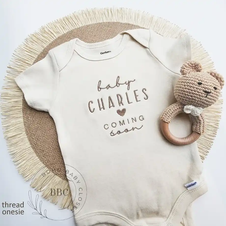 Share your joyful news with this embroidered baby name onesie. Perfect for pregnancy announcement ideas, this personalized outfit is a sweet and stylish way to introduce your little one to family and friends.