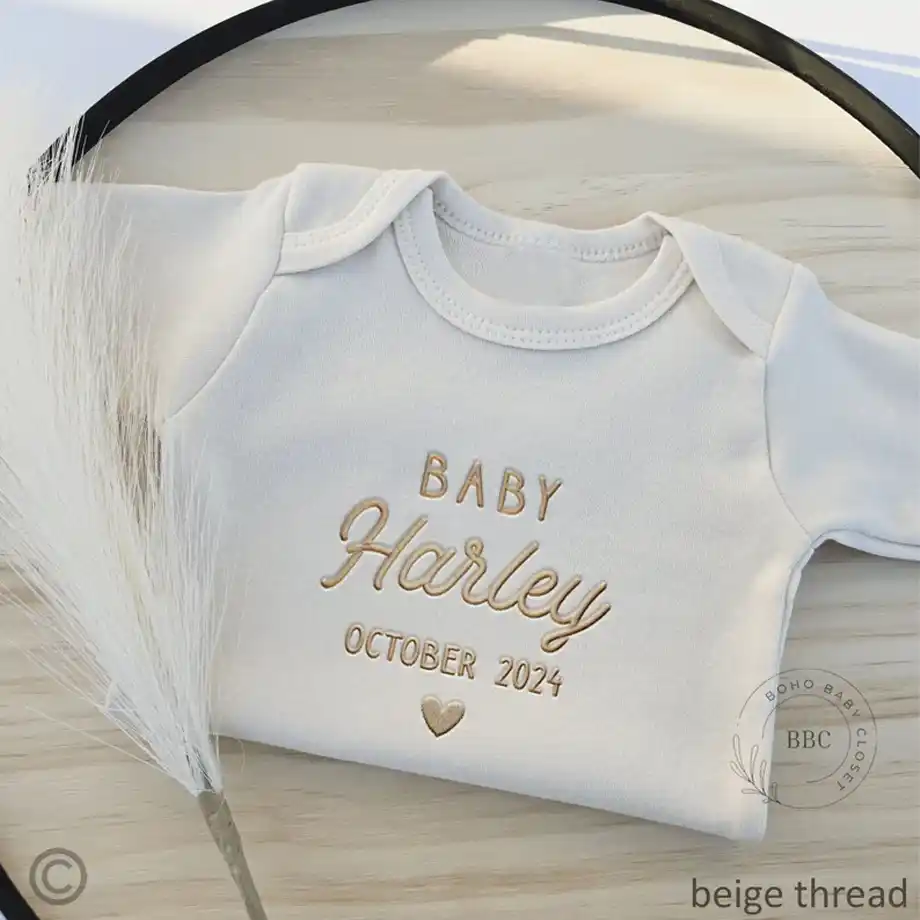 Announce your exciting news with this adorable embroidered baby name onesie. A charming and unique choice for pregnancy announcement ideas, perfect for sharing your joy with loved ones.