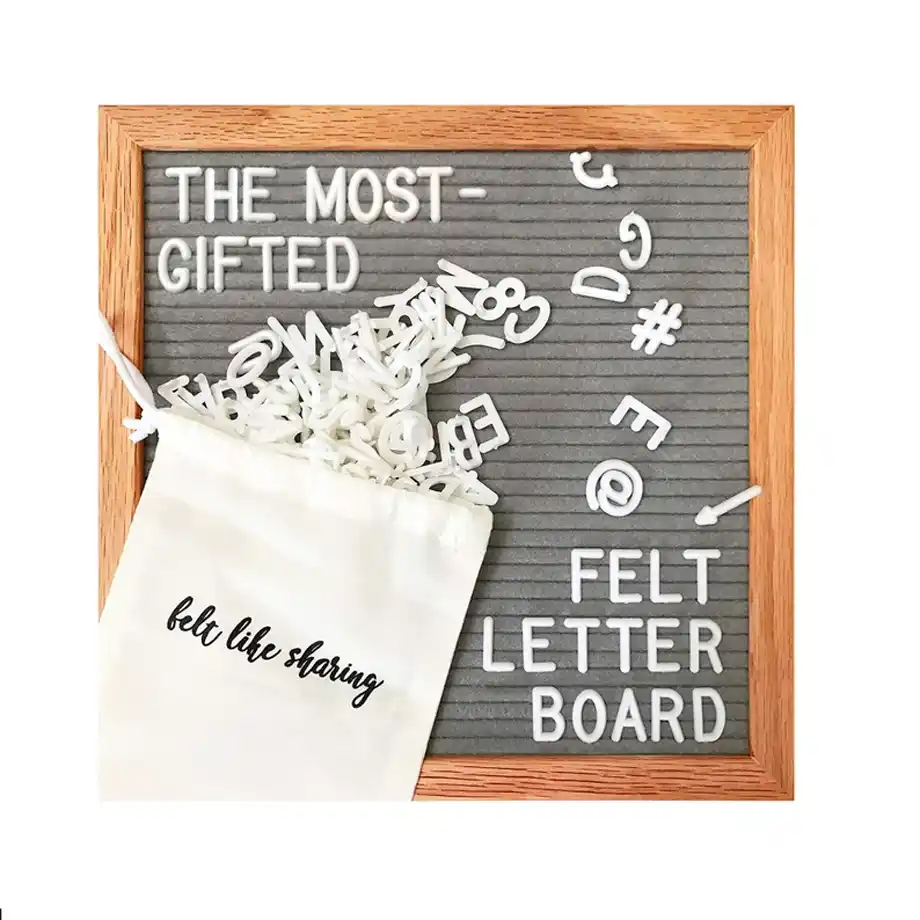 A gray handmade felt letter board set with customizable letters, styled with cozy decor, perfect for creative and heartwarming pregnancy announcement ideas.