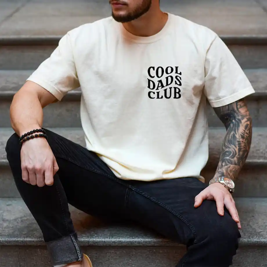 Reveal your pregnancy news in style with this 'Cool Dads Club' shirt. A humorous and thoughtful way to announce your big news, perfect for fun pregnancy announcement ideas.