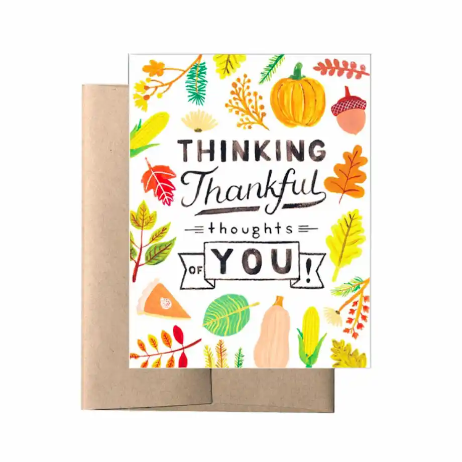 A Thanksgiving greeting card with a hand-drawn design of autumn elements like pumpkins, leaves, and acorns, featuring the text "Thinking Thankful Thoughts of You."