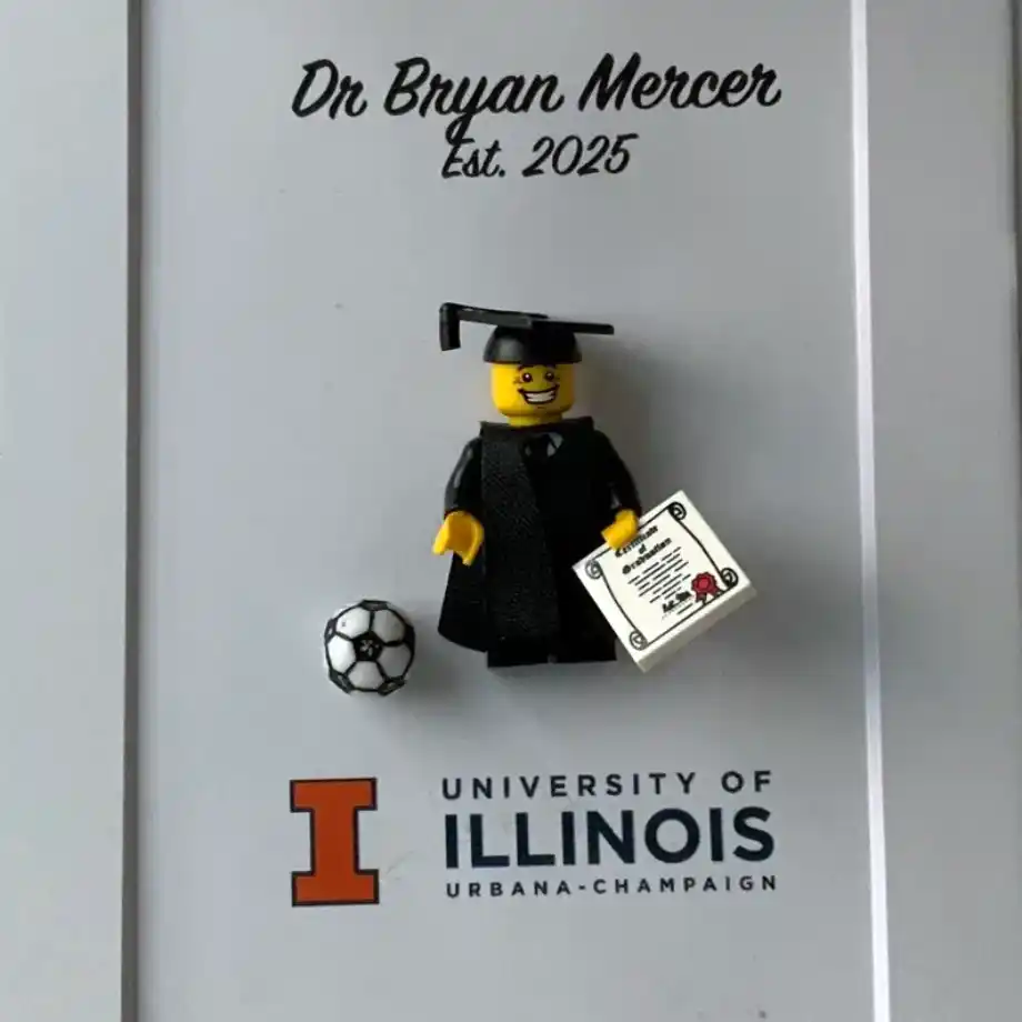 A creative photo frame featuring a personalized mini figurine alongside a photograph, designed for a unique and fun display.