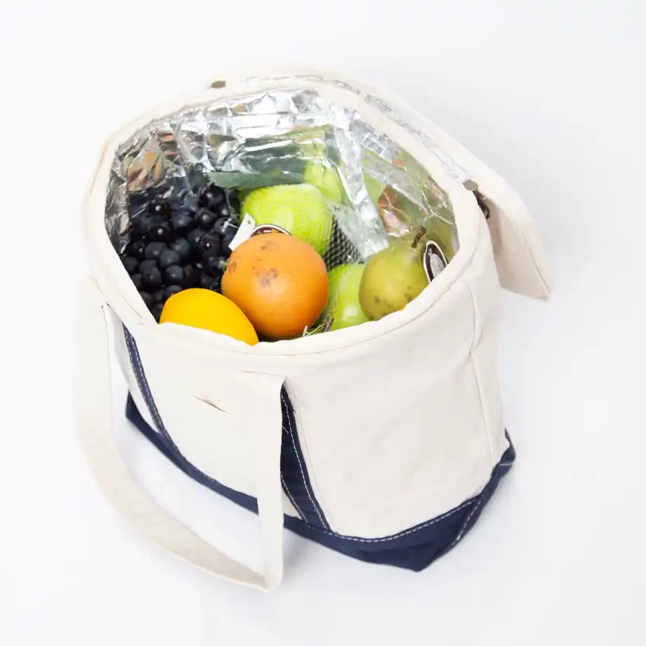 A reusable insulated cooler bag filled with fresh fruits, perfect for sharing birthday wishes for a coworker with a practical and healthy gift.