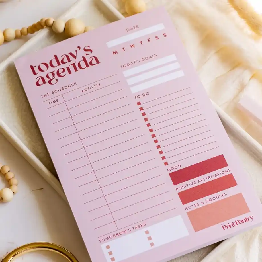 A stylish daily agenda notepad with a to-do list layout, ideal for planning tasks or crafting bulletproof excuses to get out of work effectively and professionally.