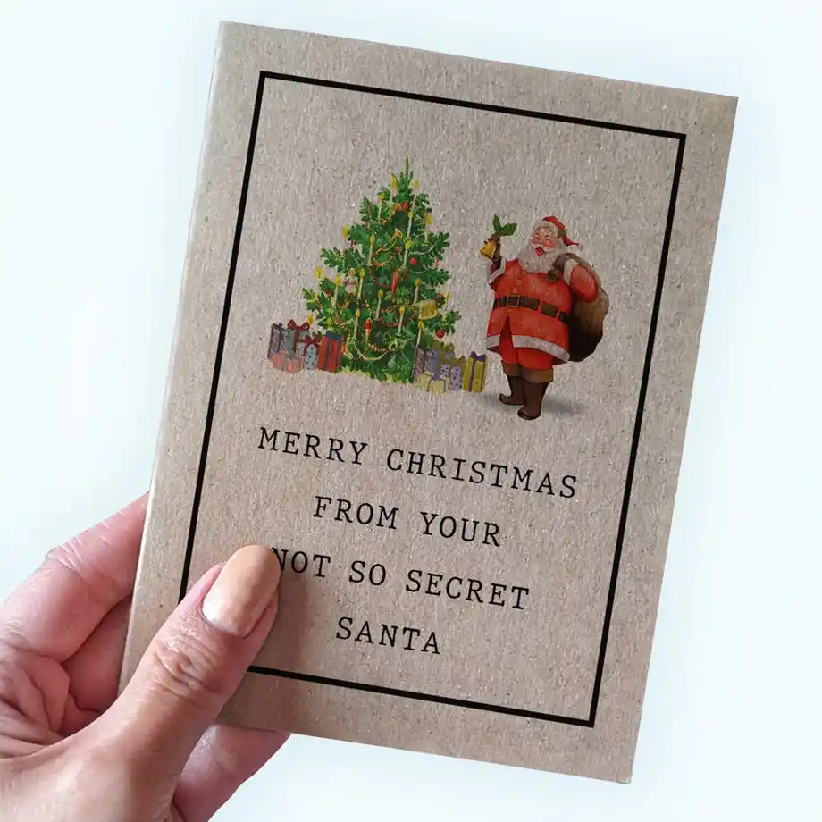 A festive Christmas card featuring Santa holding a bell next to a decorated Christmas tree, with the text 'Merry Christmas from your not so secret Santa' – ideal for sharing Christmas jokes and holiday cheer.