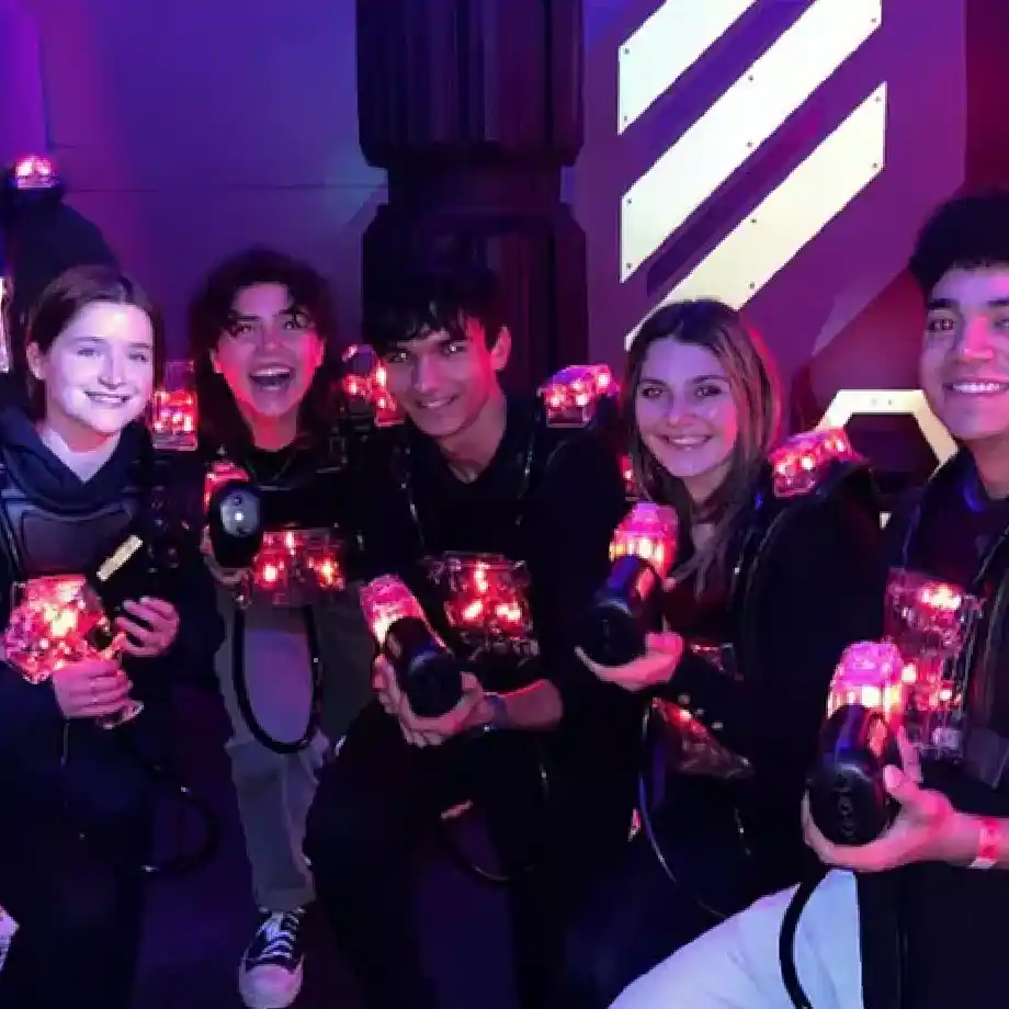 A group of friends enjoying a thrilling laser tag session, perfect for fun and engaging first date ideas.