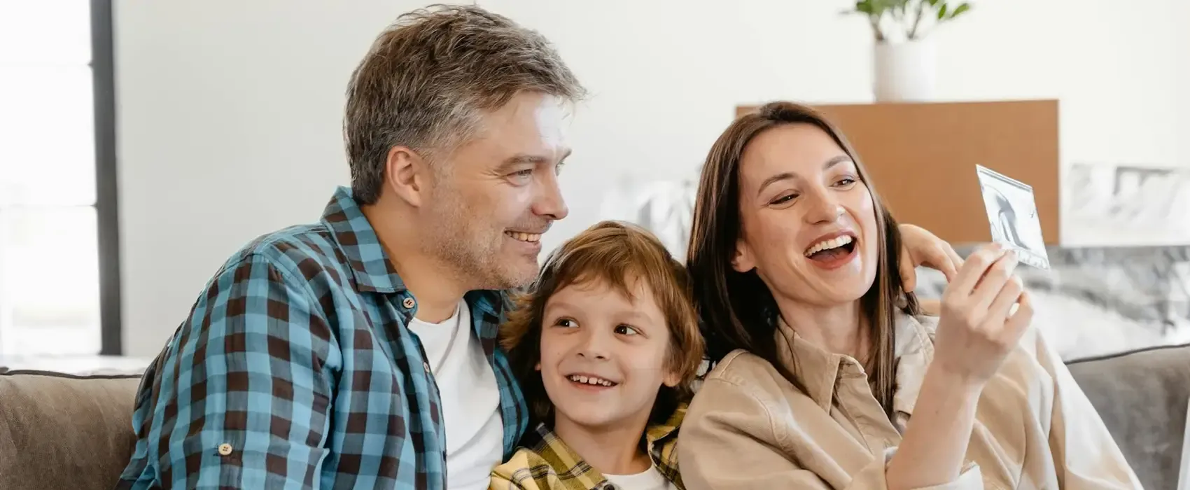 A man and woman laughing together while holding a smartphone, enjoying funny jokes. A perfect moment of humor and connection, showcasing the joy of sharing laughs with loved ones.