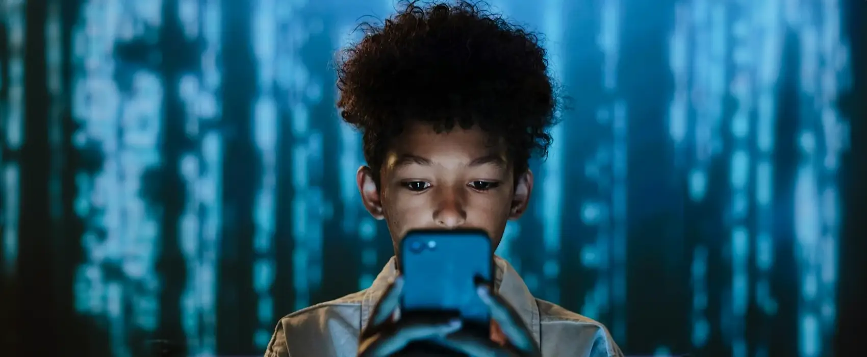 A Gen Alpha child focused on using a smartphone, surrounded by a futuristic digital background, representing the tech-savvy nature of this generation