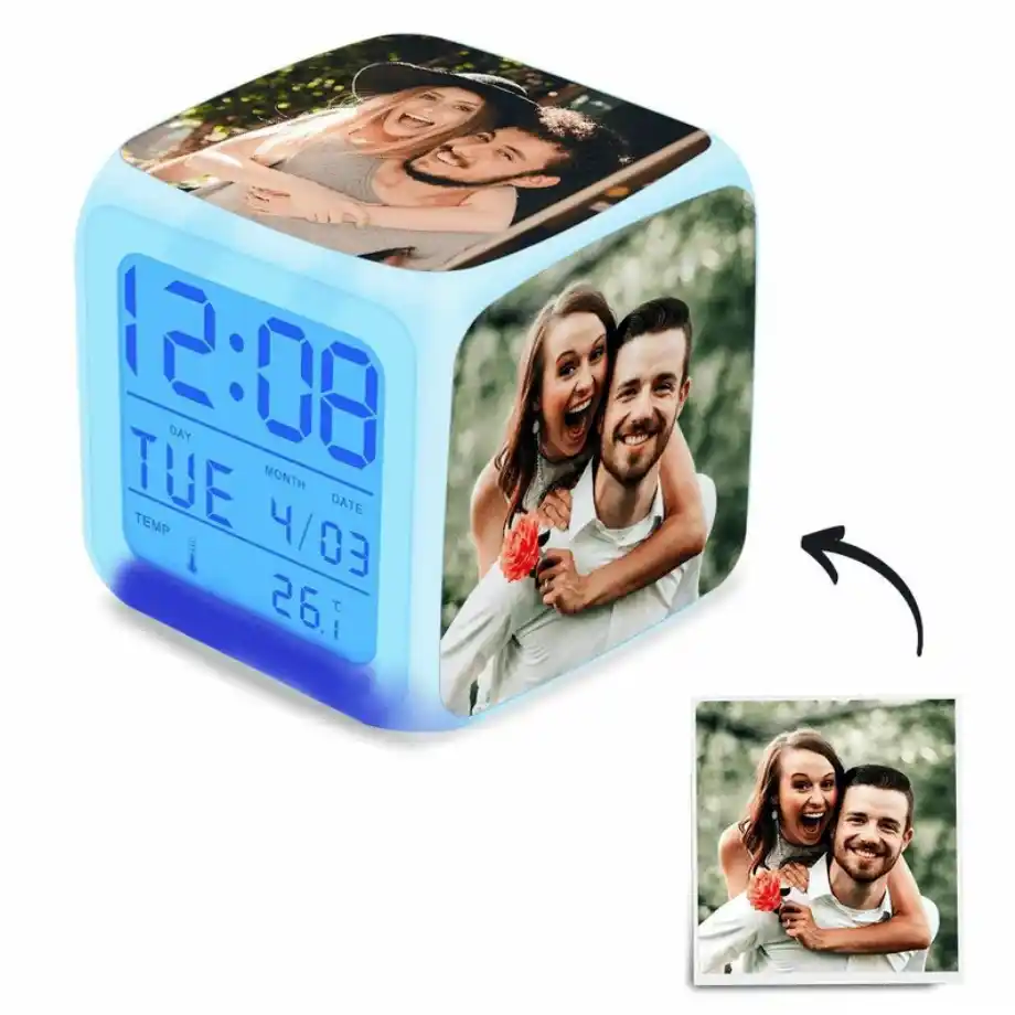 Good morning message for her: A customizable LED photo cube alarm clock showing 12:08, with multiple photo panels featuring a smiling couple in a playful pose.