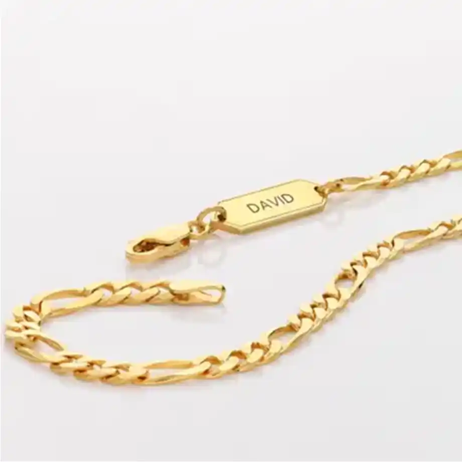 A stunning custom gold chain necklace featuring a delicate pendant engraved with initials or a meaningful symbol. The elegant design adds a personal touch, making it a perfect gift for someone special.