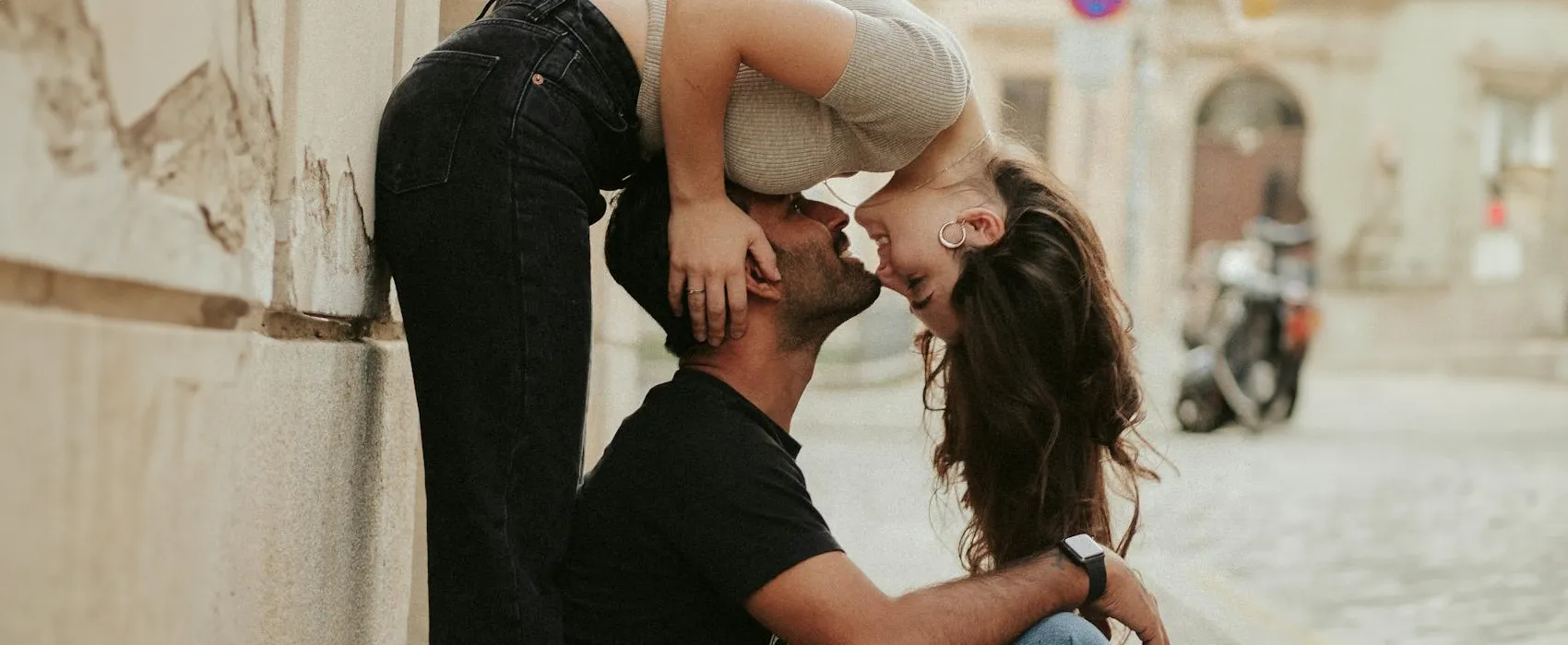 Playful couple sharing a romantic moment on the street, reflecting deep connection inspired by questions for couples