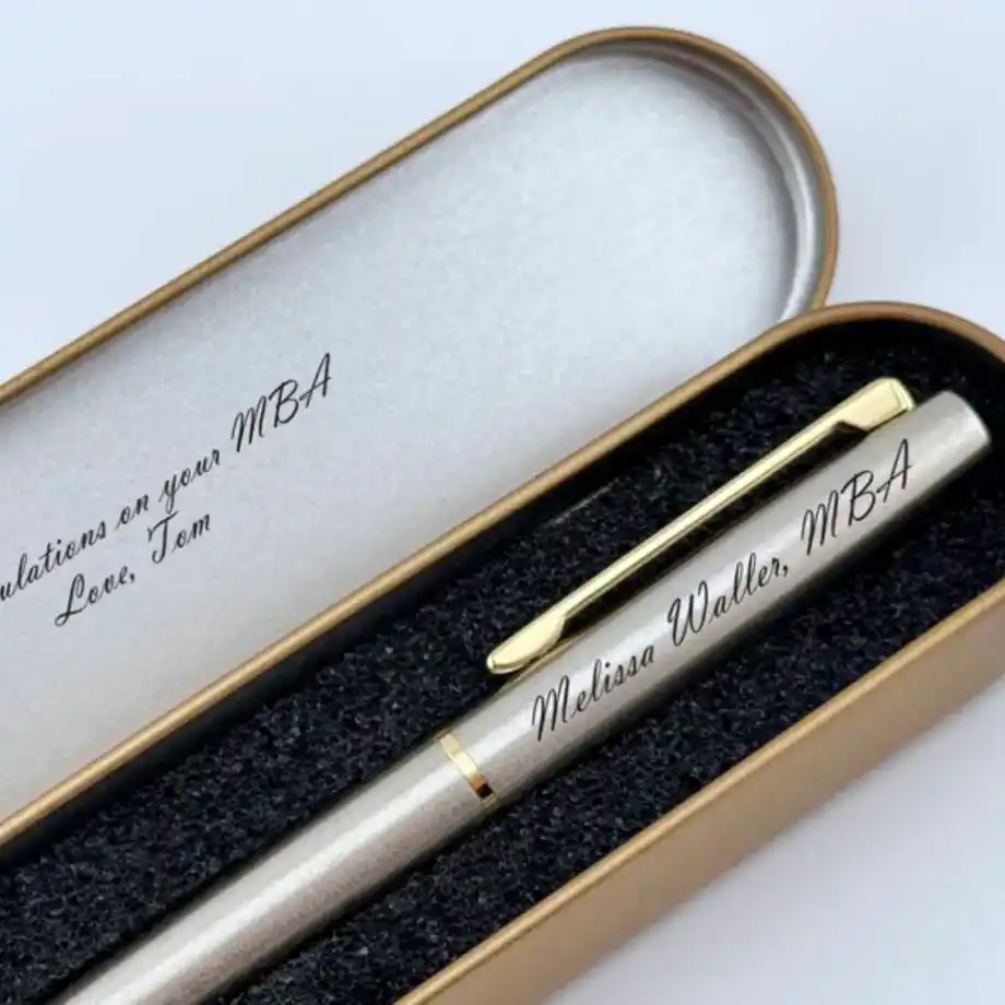 A sleek engraved pen, perfect for a graduate to sign important documents or cherish as a keepsake, making it a practical and thoughtful graduation gift idea