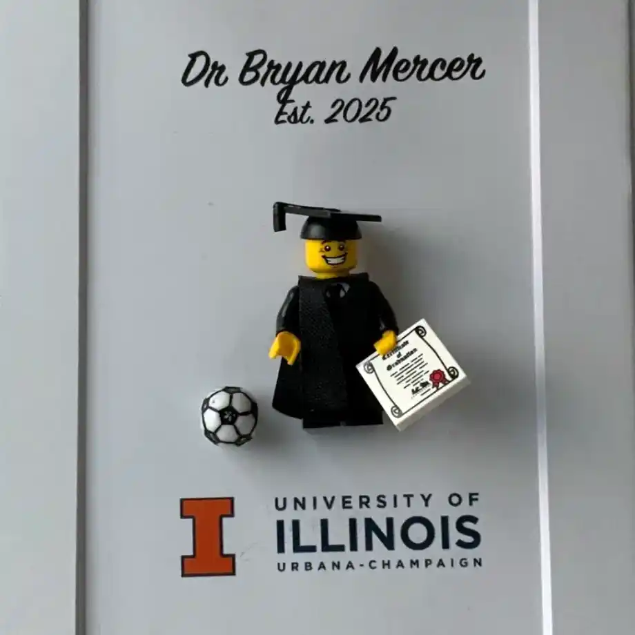 "LEGO-themed photo frame featuring a customizable design, perfect for displaying graduation photos and celebrating achievements like the University of Illinois class of 2025. A creative and fun graduation gift idea."