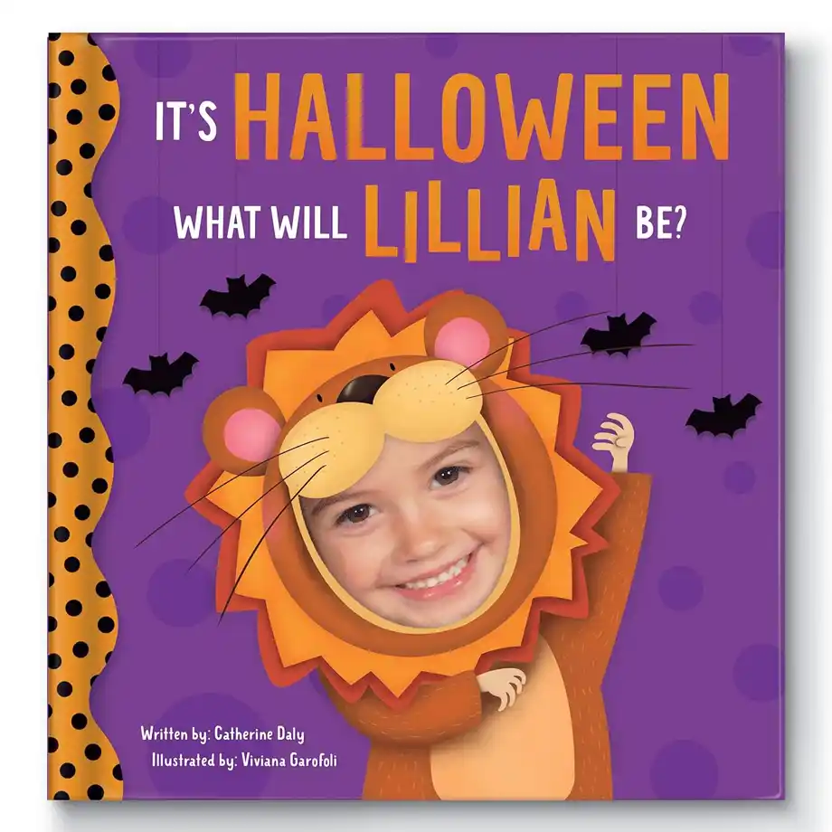 A personalized children's Halloween book with a vibrant purple cover featuring a child's face in a lion costume. The title reads, "It's Halloween, What Will Lillian Be?" with playful bat illustrations. This customized book makes a delightful addition to a boo basket, creating a fun and festive Halloween gift for kids.