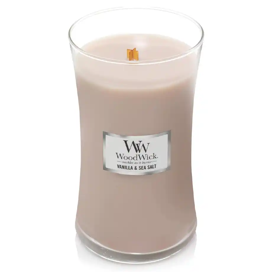 A WoodWick Vanilla & Sea Salt candle in a stylish glass jar with a wooden lid. This elegant scented candle features a crackling wick, making it a perfect choice for white elephant gift ideas that bring warmth and relaxation to any space.