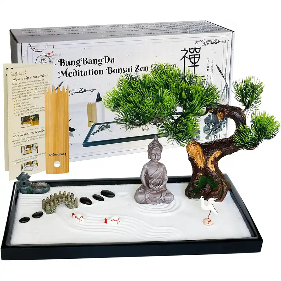 A beautifully designed mini Zen garden set featuring a bonsai tree, Buddha statue, sand tray, rocks, and decorative elements for meditation and relaxation. This stylish and calming set makes a unique and thoughtful choice for white elephant gift ideas, perfect for home or office decor.