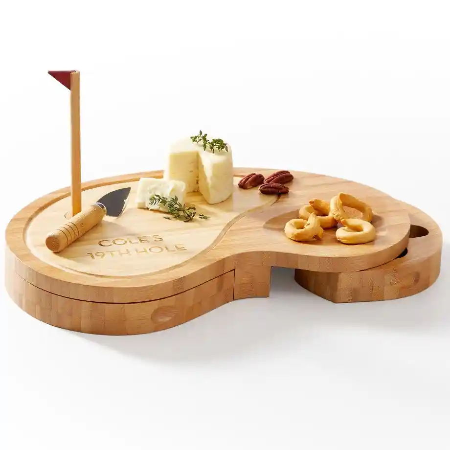 A stylish golf-themed cheese board with carved-out sand traps for garnishes and a hidden compartment for cheese tools. Complete with a removable magnetic flag pole, this fun and functional set is perfect for entertaining golf enthusiasts at home, on game nights, or at golf-themed parties.