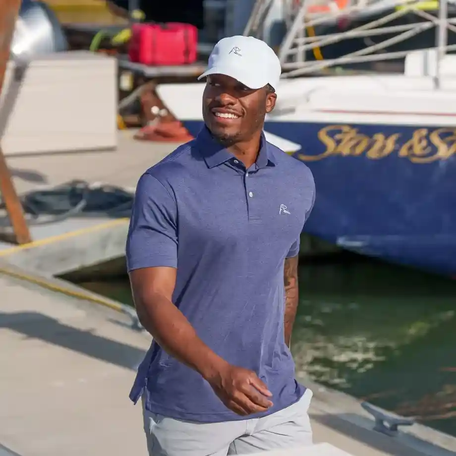 Heather performance polo in Annapolis Blue/Blue Steel, designed with moisture-wicking fabric for all-day comfort, perfect for golf, casual wear, or outdoor activities.