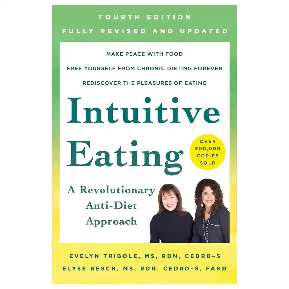 The cover of Intuitive Eating: A Revolutionary Anti-Diet Approach by Evelyn Tribole and Elyse Resch. The book promotes a healthy relationship with food, challenging diet culture and almond mom tendencies. The cover features a green and yellow gradient background, bold typography, and photos of the two authors smiling. A yellow badge highlights that over 500,000 copies have been sold.