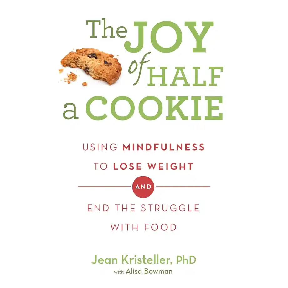 The cover of The Joy of Half a Cookie by Jean Kristeller, PhD, with Alisa Bowman. The title is in bold green and red typography, accompanied by an image of a half-eaten oatmeal raisin cookie with crumbs scattered beside it. The subtitle reads, "Using mindfulness to lose weight and end the struggle with food," suggesting an alternative to restrictive eating habits often associated with the almond mom mindset.