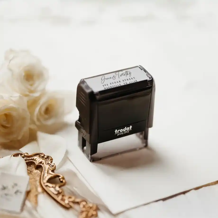 A beautifully designed custom calligraphy return address stamp, perfect for adding a personal touch to wedding invitations or thank-you notes. A thoughtful and practical addition to engagement gift ideas for newly engaged couples.