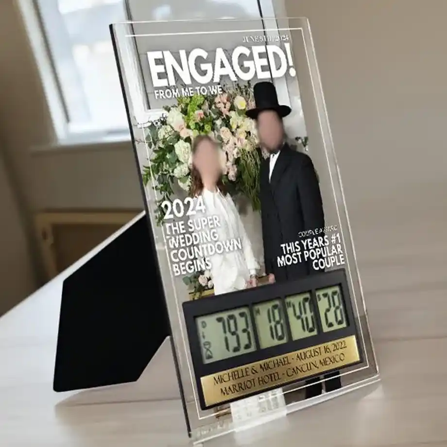 A custom acrylic wedding countdown timer featuring a magazine-style design with a couple’s photo, engagement details, and a digital countdown display. This elegant and personalized keepsake is one of the best engagement gift ideas for couples eagerly anticipating their big day. Perfect for displaying on a desk or shelf, it serves as a daily reminder of the special journey toward marriage.