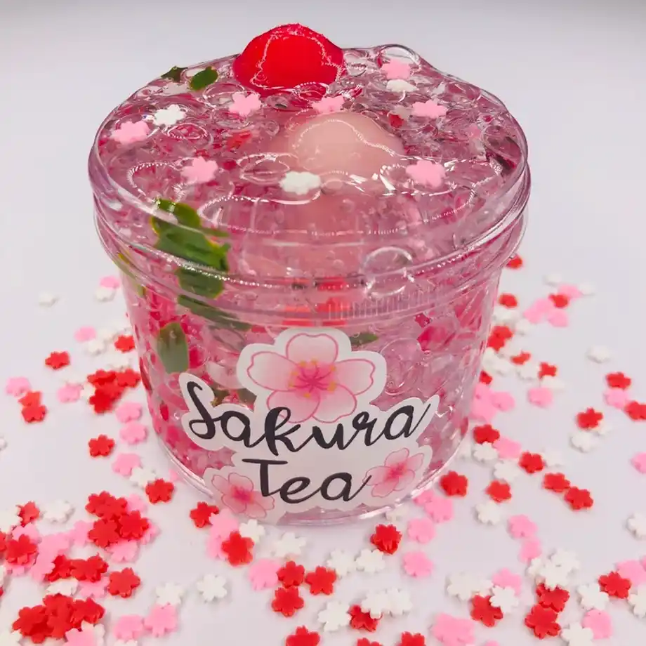 Sakura Tea Fishbowl Slime, a clear slime with a fun, bubbly texture and a soothing aroma. If you're wondering how to get slime out of clothes, this slime can be easily cleaned up with the right stain removal techniques, making it perfect for playful hands.